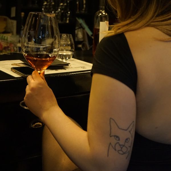 Guest enjoying a glass of Greek wine at Cantina by Cinque.