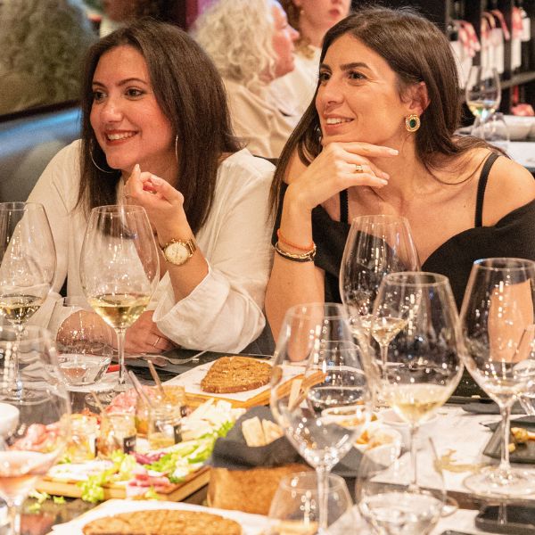 Guests enjoying a Greek wine tasting experience with food pairings at Cinque Wine & Deli in Athens.