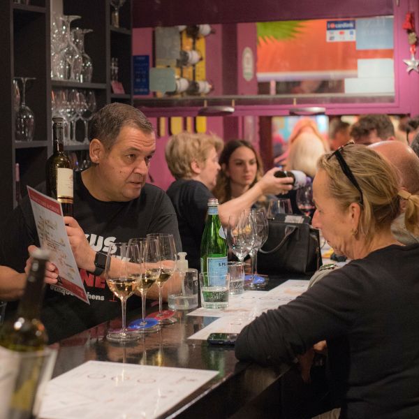 Wine professional guiding guests through a Greek wine experience.