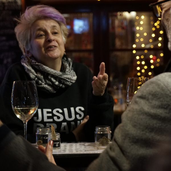 Guest speaking with a wine host at Cantina by Cinque.