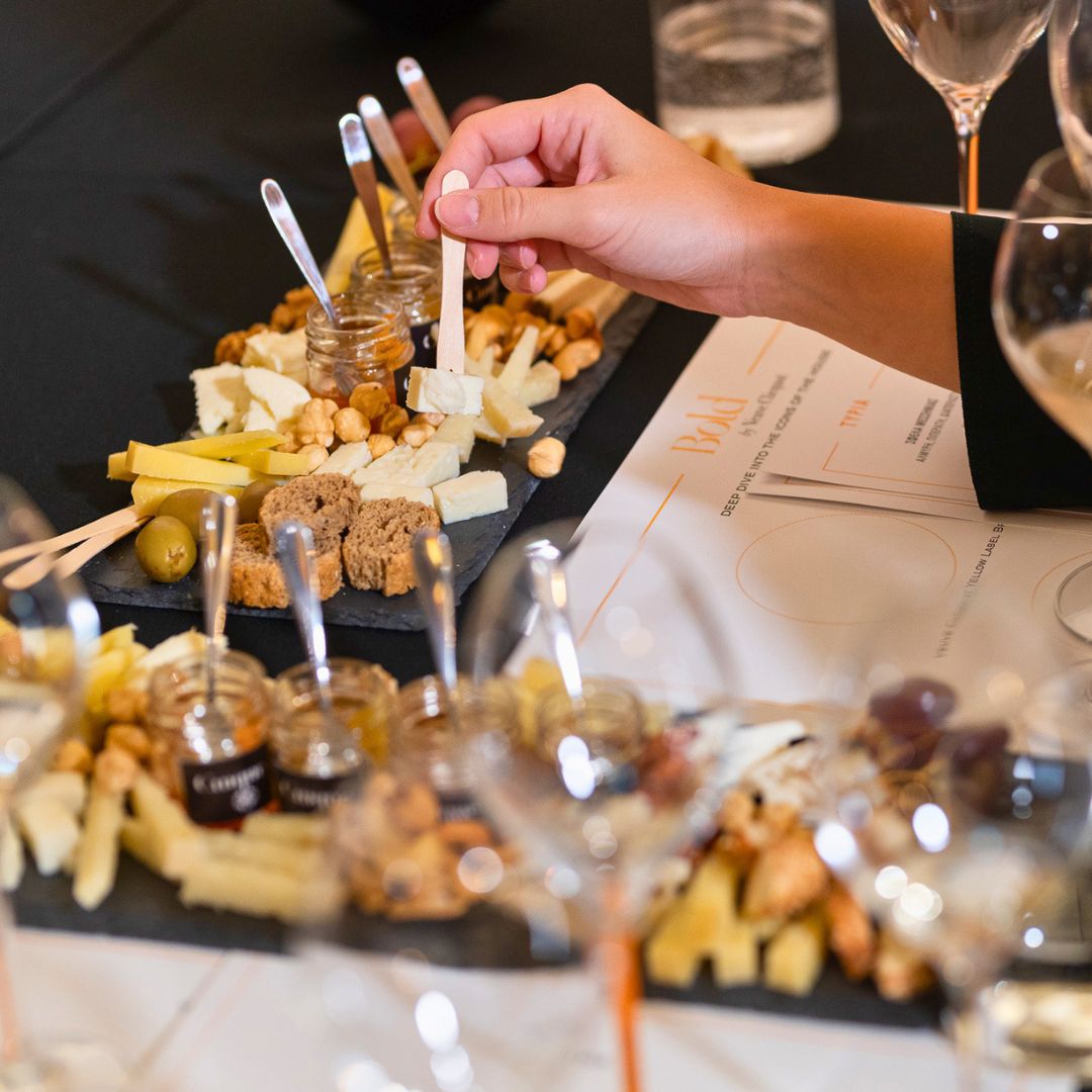 Greek wine tasting experience featuring curated cheese pairings, local products and guided hospitality experiences.