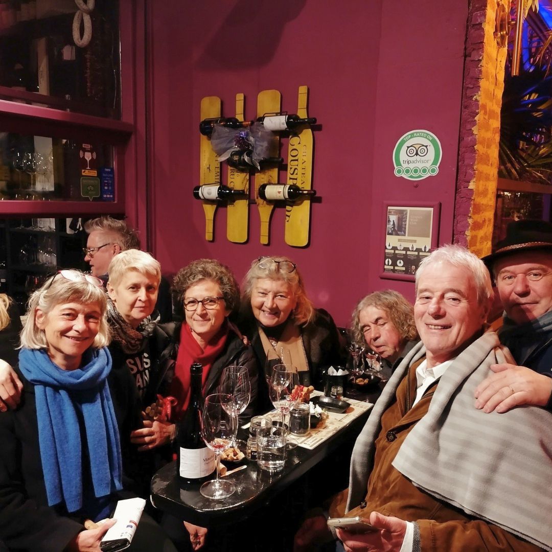 International guests sharing wine and conversation during a Greek wine experience.