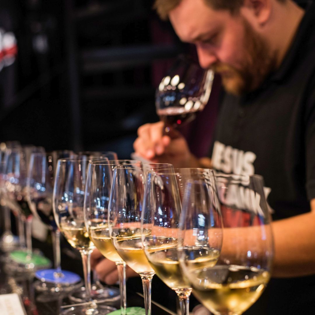 Guest evaluating and tasting Greek wines during a professional guided wine tasting session.